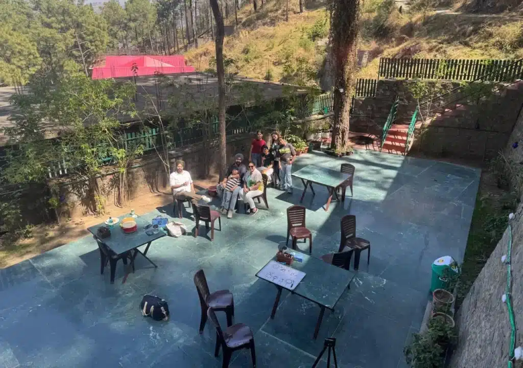 Guests enjoying their time at the Bunker Café in Kasauli, smiling and looking at the camera.